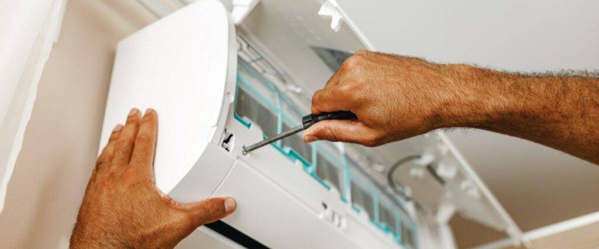 close-up-of-repairman-fixing-air-conditioner-in-a-2021-09-03-17-24-01-utc-min-1024x683