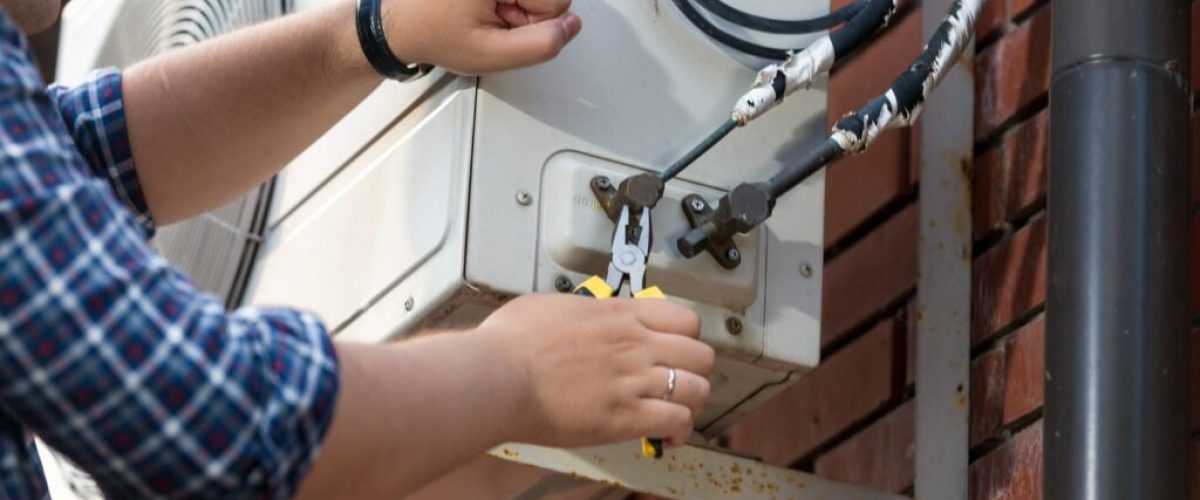 closeup-of-male-technician-repairing-outdoor-air-c-2021-12-09-17-34-31-utc-min-1024x683