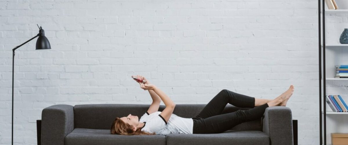 happy-young-woman-using-smartphone-on-sofa-under-a-2021-08-29-22-50-42-utc-min-1024x683 (1)
